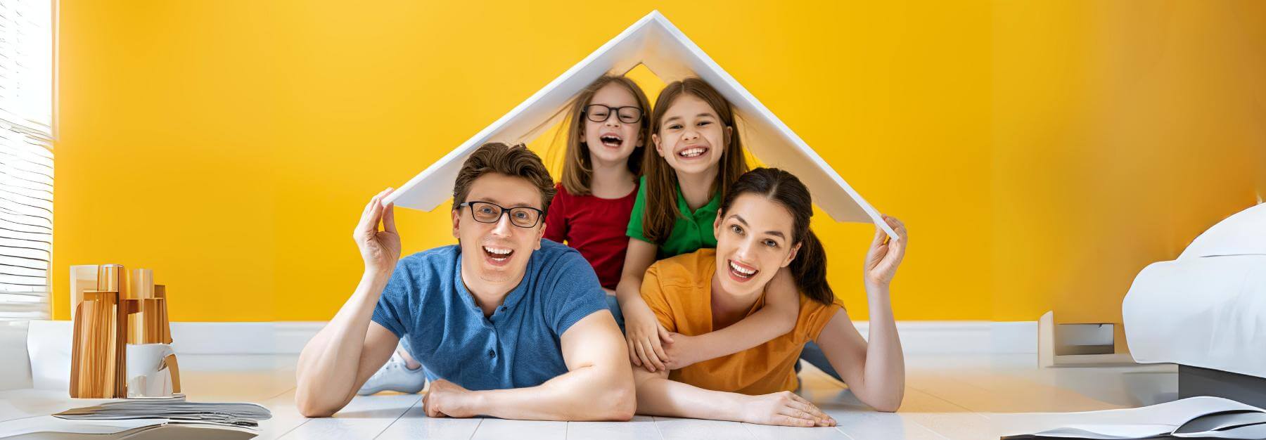 Family opportunity mortgage: Four people holding a model house roof over their heads in a room with a yellow wall.